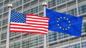 US and European flags waving in the wind (3D rendered)