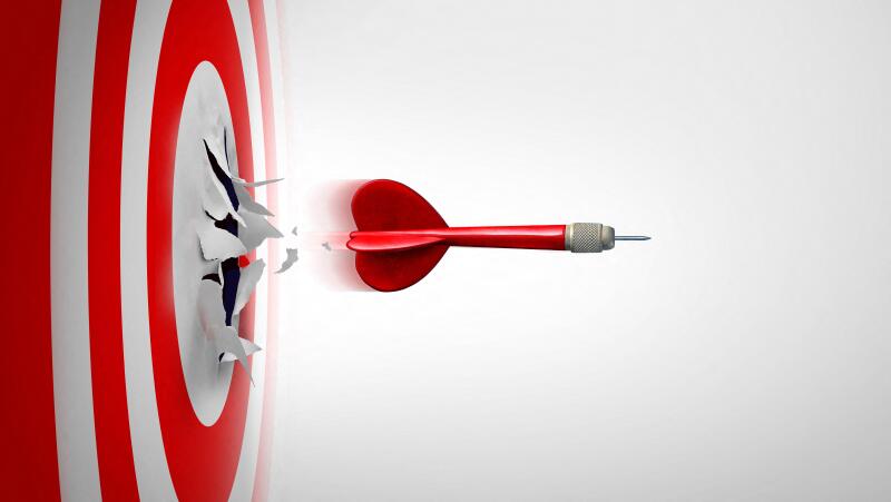 Setting New Goals and Breaking through or overcoming challenges as a dart representing entrepreneurship and unlimited business success focus blasting