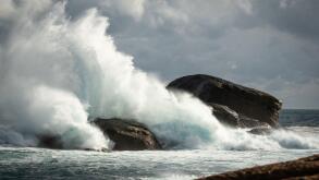 Rough stormy weather big splash of waves on rocks at Redgate Beach, Western Australia
