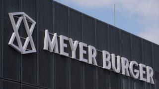 Thalheim, Germany. 18th May, 2021. View of the entrance to the Swiss company Meyer Burger in Thalheim. The production of solar cells starts here with an annual nominal capacity of 400 megawatts. Saxony-Anhalt supports the company's production, according t
