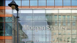 Facade of the modern bank of Morgan Stanley with reflections and a nostalgic lantern in London,