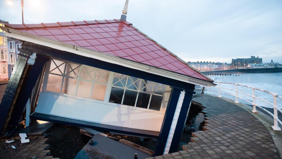 Aberystwyth Wales UK, Tuesday 07 Jan 2014 As the stormy weather subsides, the full impact of several days of huge tides and massive waves becomes clear to see on Aberystwyth promenade, Wales UK. The iconic and historic public shelter lies in ruins as its
