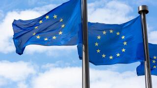 Close up of two European Union Flags flying outside the Berlaymont Building in Brussels, Belgium.