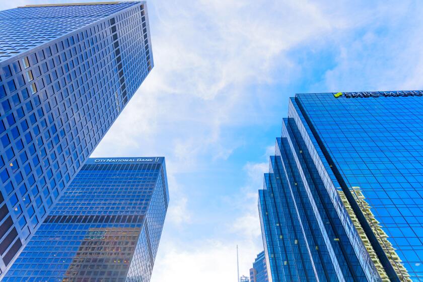 Los Angeles, California - January 7, 2025: Dynamic view of TCW Tower, City National Bank, and SMBC Manubank set against a bright blue sky, highlightin