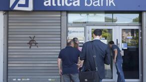 People line up at an ATM outside an Attica Bank branch in Athens, Greece on July 8, 2015.  Greece asked for more funds from the European Union as it prepared a last ditch effort on economic reforms to stay in the Euro before a fast-approaching deadline.  