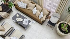 Meringues and tea on coffee table with chrome legs in front of Gervasoni rattan sofa with pillows and leather ottoman in orangery 


UK AND IRISH RIGH
