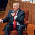 Donald Trump is seated answering questions at the Economic Club of New York.