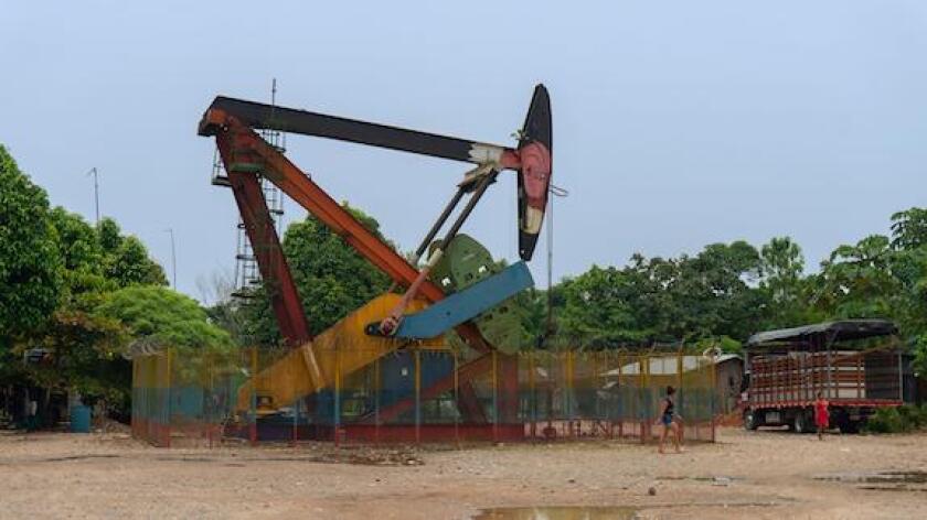 La Dorada, Putumayo / Colombia - March 8 2020: Women walking near a producing oil well near La Dorada village on a sunny day