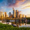 Golden sunrise view of the skyline of Frankfurt am Main, Germany, with banking skyscrapers, Eiserner Steg Bridge and River