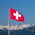 Swiss flag and Alps