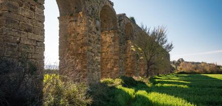 Ancient Roman aqueduct ruins of Aspendos in green spring landscape