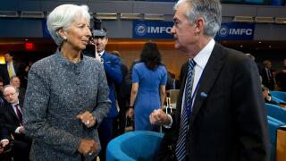 International Monetary Fund (IMF) Managing Director Christine Lagarde speaks with Federal Reserve Board Chair Jerome Powell during the International Monetary and Financial Committee meeting, at the World Bank/IMF Spring Meetings in Washington, Saturday, A