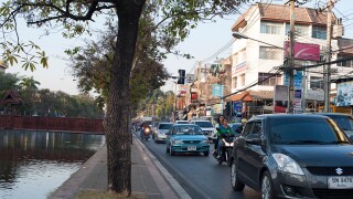 Busy road alongside the Ping Canal in Chiang Mai, Northern Thailand.