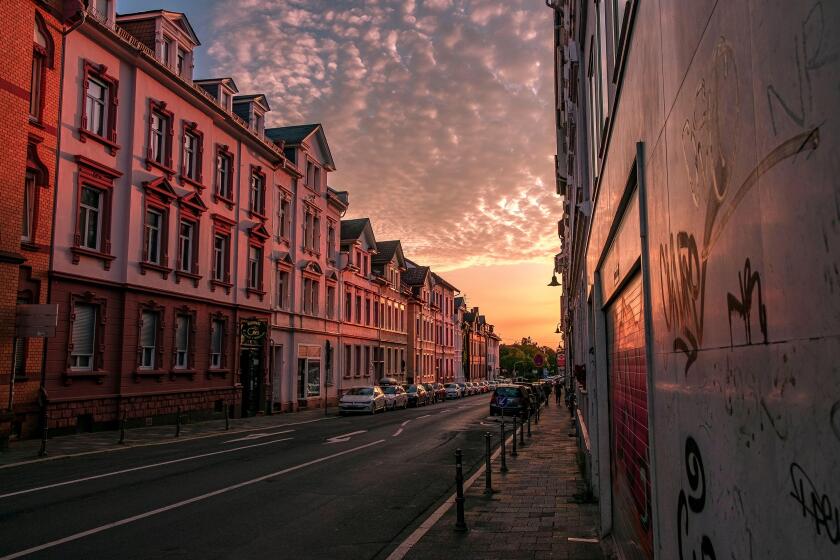 sunset on the street in Germany with warm color clouds and nearly empty street