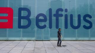 A man walks by the new logo and name for Belfius bank (formerly Dexia) in Brussels on Thursday, March 1, 2012. The bank unveiled its new name and logo on Thursday. (AP Photo/Geert Vanden Wijngaert)
