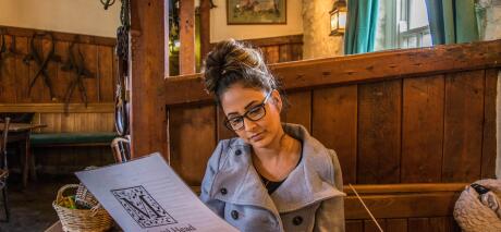 Girl reading menu at pub