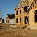 New suburban housing development under construction with finished and newly framed houses