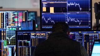 A trader works on the floor of the New York Stock Exchange, Tuesday, March 11, 2025. (AP Photo/Richard Drew)