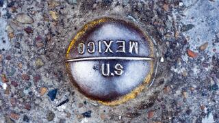 US-Mexico border marker in the road at the San Ysidro, San Diego crossing. Law enforcement agencies have found numerous tunnels along the boarder used for drugs trafficking. See description for more information