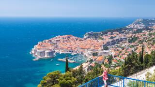 Croatia Dubrovnik Croatia Dalmatian coast woman admiring the view to Dubrovnik old town harbour old port croatia