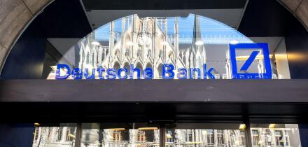 Deutsche Bank logo on the window of a branch in Munich