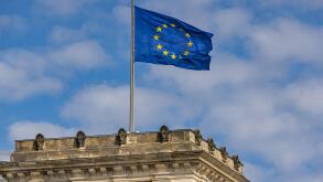 The EU European Union flag flies on top of the Reichstag German Parliament (Bundestag) building, Berlin, Germany