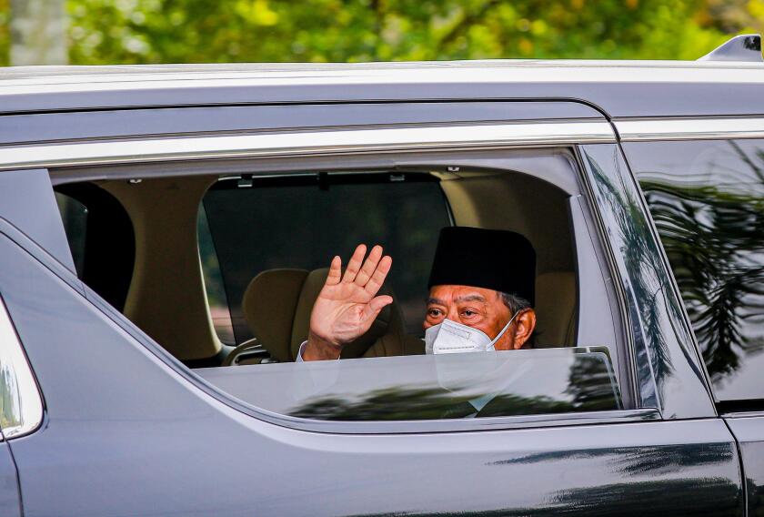 Kuala Lumpur, Malaysia. 04th Aug, 2021. Malaysia's Prime Minister Muhyiddin Yassin waves at the media as he arrives at the National Palace for an audience with King Al-Sultan Abdullah Ri'ayatuddin Al-Mustafa Billah Shah in Kuala Lumpur. United Malays Nati