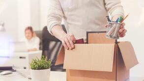 Sad dismissed worker taking his office supplies with him
