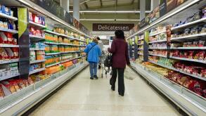 Shoppers at the aisle at Tesco supermarket food hall, UK