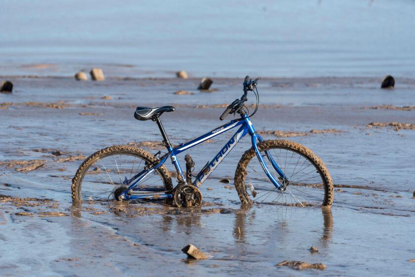 Bike stuck in river mud at New Brighton, Merseyside, England