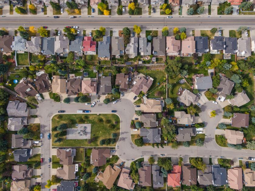 Aerial top down view of houses and streets in beautiful residential neighborhood during fall season in Calgary, Alberta, Canada.