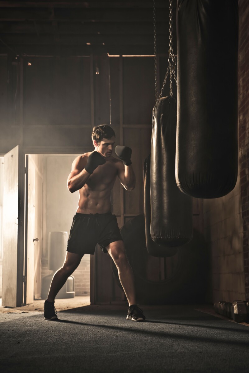 Caucasian boxer hitting punching bag