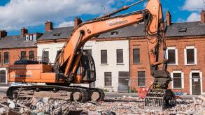 A demolition excavator on an inner city site where houses are being demolished.