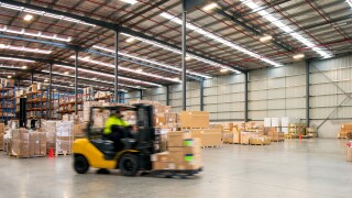 Forklift working at logistics warehouse