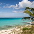 Calm sea and beach with a boat in the distance, South Bimini, Bahamas. The Bahamas National Shark Sanctuary, West Atlantic Ocean.