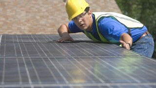 Installing solar panel rooftop from Adobe 9Jul20 575x375