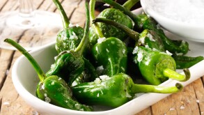 Whole griddled Padron peppers snack with sea salt