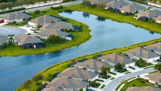American gated community houses in rural US suburbs. View from above of large residential homes in small town in southwest Florida.