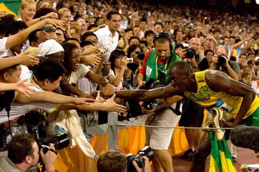 Jamaica's Usain Bolt jubilates with an adoring crowd after smashing the 100m world record with a time of 9.96 to win the Olympic men's 100m final in Beijing August 16, 2008. (UPI Photo/Stephen Shaver)