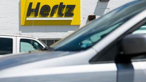 A logo sign outside of a Hertz car rental location in Silver Spring, Maryland on May 23, 2020.