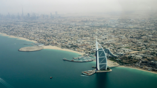 Aerial shot of the Dubai coastline, featuring the Burj Al Arab