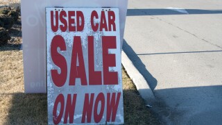 used car on sale now sign dealership dealer enter road market pavement road