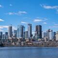 Montreal, Canada - April 4, 2025: A scenic view of Montreal's skyline from the St. Lawrence River, featuring urban architecture against a bright sky