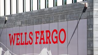 London, UK - June 22, 2018: Closeup of Wells Fargo bank branch entrance with red sign on modern building wall and nobody in England
