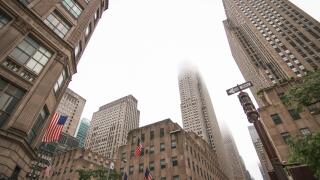 New York, 2017: A view of a street in Downtown Manhattan. High skyscrapers rising to the sky on a cloudy weather day. New York urban street