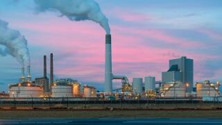 Smoke emission from factory pipes of oil refinery in night, Netherlands. Emission environment from oil refinery.