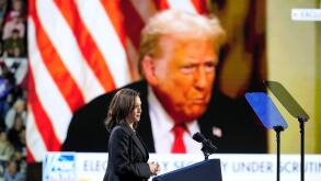 Democratic presidential nominee Vice President Kamala Harris speaks as an image of Republican presidential nominee former President Donald Trump appears on screen during a campaign rally at Erie Insurance Arena, in Erie, Pa., Monday, Oct. 14, 2024. (AP Ph