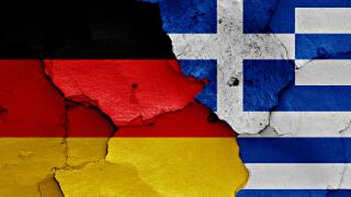 flags of Germany and Greece painted on cracked wall