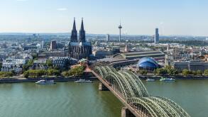 Cologne Cathedral. View over the River Rhine to Cologne Cathedral and Railway Station with the Hohenzollern Bridge in the foreground, Cologne, Germany