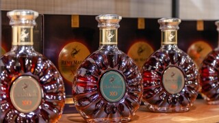 Russia Kemerovo 16-11-2018 degustation luxury vip cognac Remy Martin XO in crystal bottles stands in line on wooden shelves. The concept of advertisin